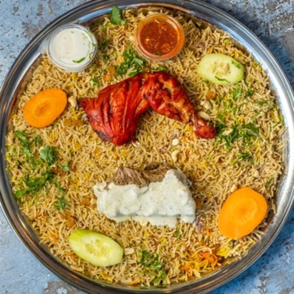 Hello! India's Mandi platter with chicken, lamb, rice, sauces, and vegetables.